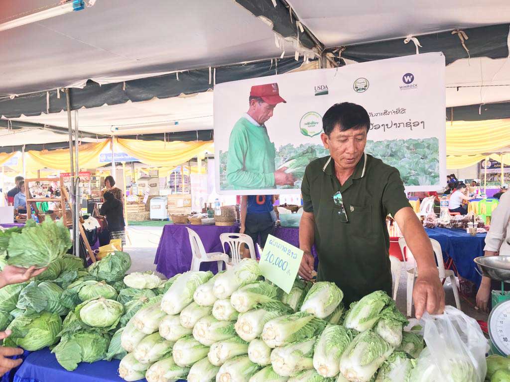 Farmer selling certified vegetables at a market