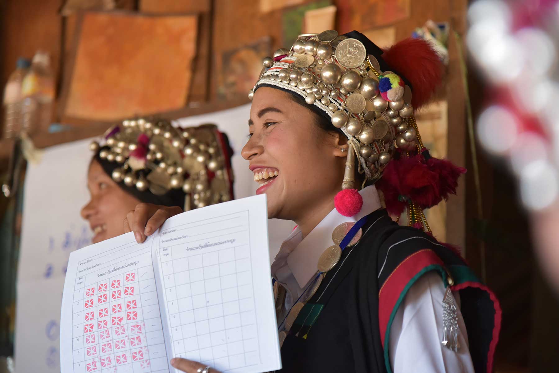Hill tribe teachers holding up a course book